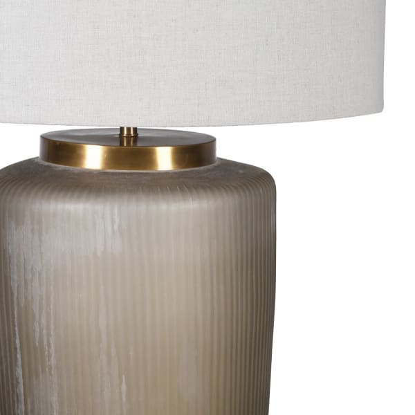 Close-up of hand-cut smoked glass and brass detailing on Fritzovia table lamp