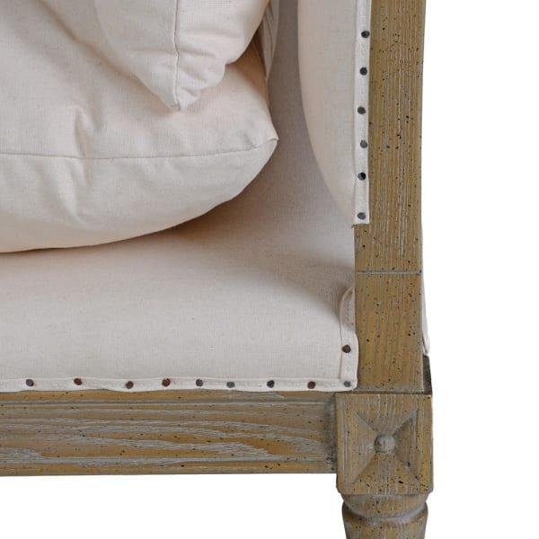 Close-up of ash wood frame, nailhead trim and linen cotton upholstery on Cooper bench