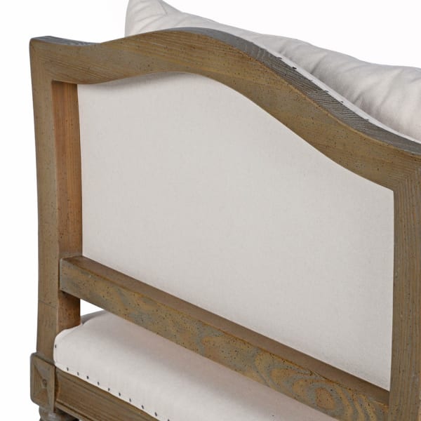 Close-up of ash wood frame, nailhead trim and linen cotton upholstery on Cooper bench
