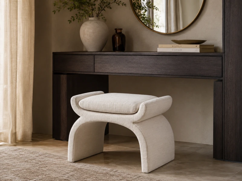 Cream bouclé stool with sculptural curved base