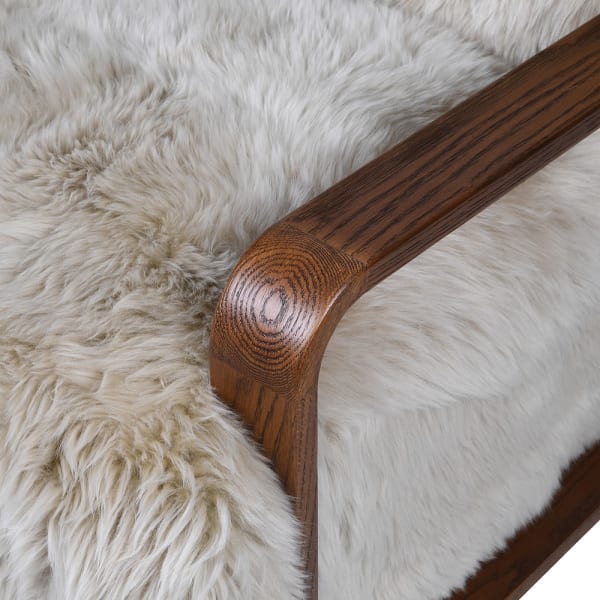 Highgate armchair detail showing sheepskin upholstery and curved oak arm