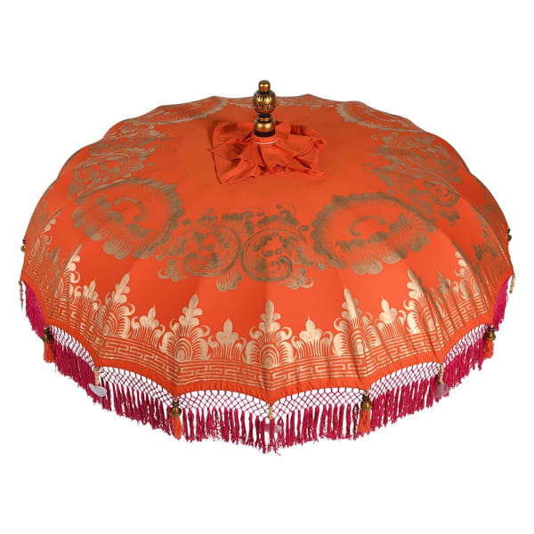 Red and gold oriental garden parasol with decorative pink fringe