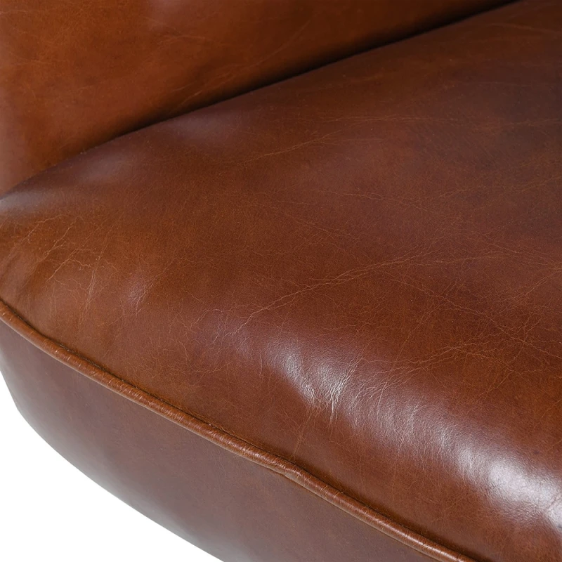 Close-up of brown leather upholstery on Chelsea armchair