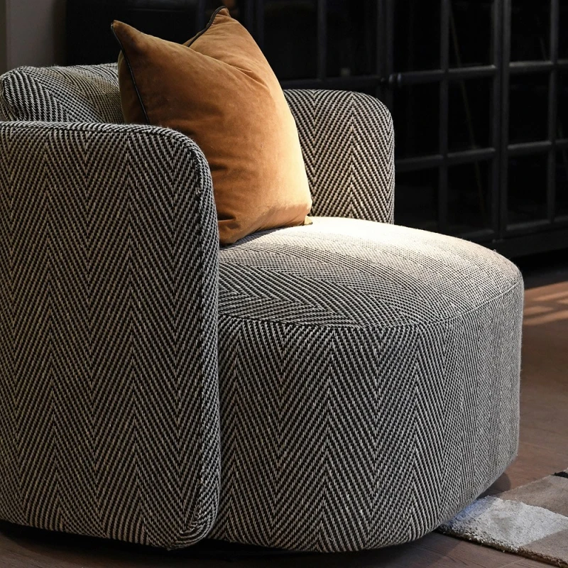 Fitzrovia patterned swivel armchair styled with a warm brown cushion
