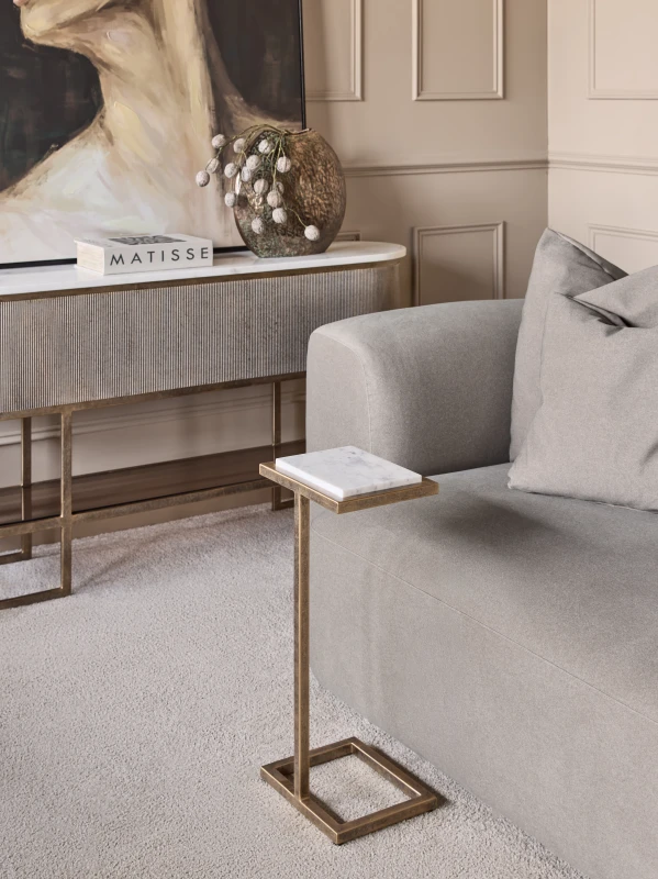 Alice Mini marble side table beside a sofa in an elegant living room
