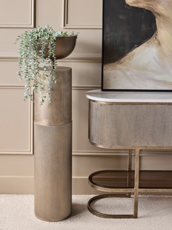 Primrose tall pedestal planter beside a console in an elegant living room