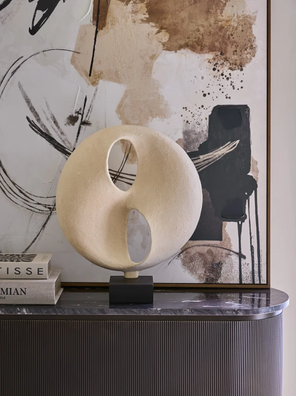 Solenne cream abstract sculpture styled on a sideboard in a refined interior