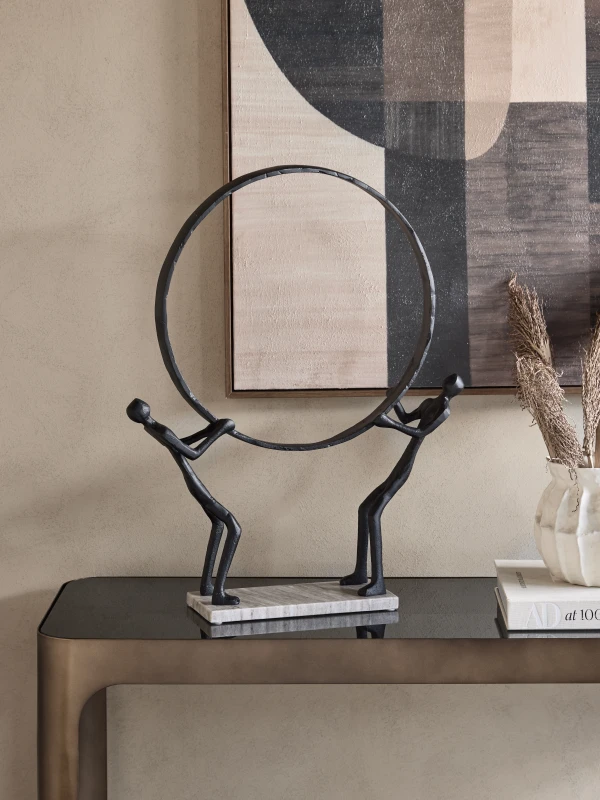 Balance abstract sculpture styled on a console table in a refined interior