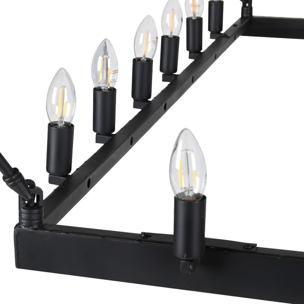 Close-up of black metal chandelier frame and candle-style lights