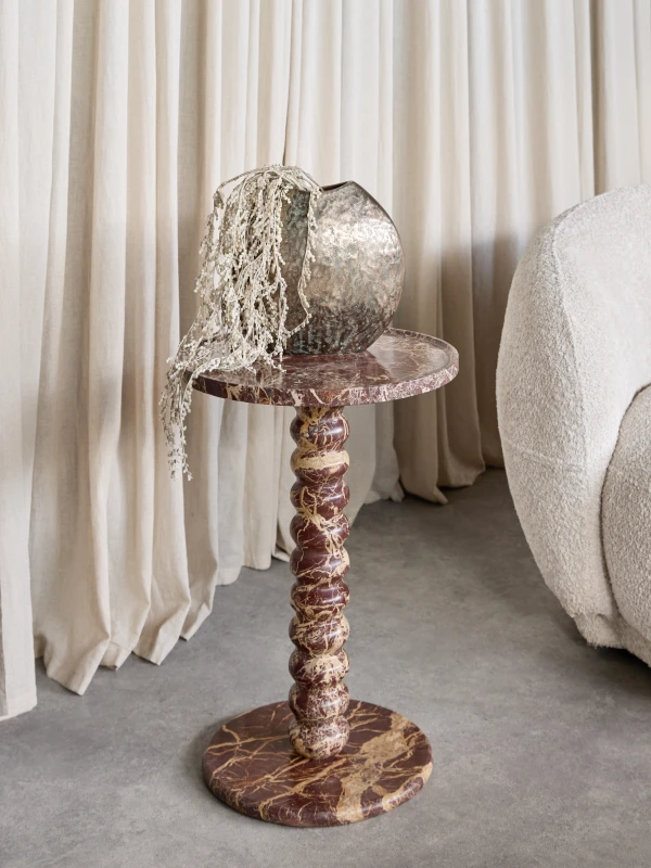 Round red marble side table with sculptural pedestal