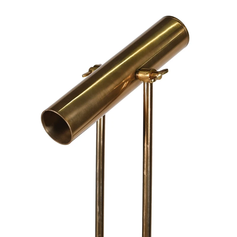 Tubular gold-toned metal light housing and supports of Langford floor lamp