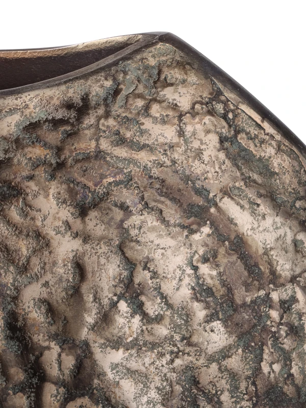 Mottled bronze and green-grey patina detailing on textured aluminium vase