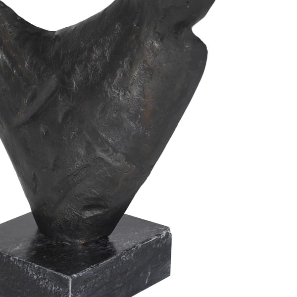 Large black metal sculpture with two curved forms on a square marble base