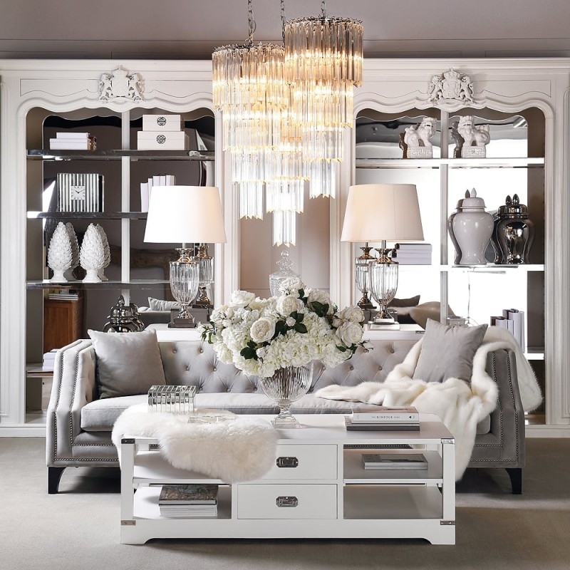 Light grey upholstered sofa with decorative button armrests