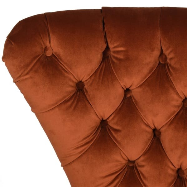 Burnt-orange velvet accent chair with deep button tufting