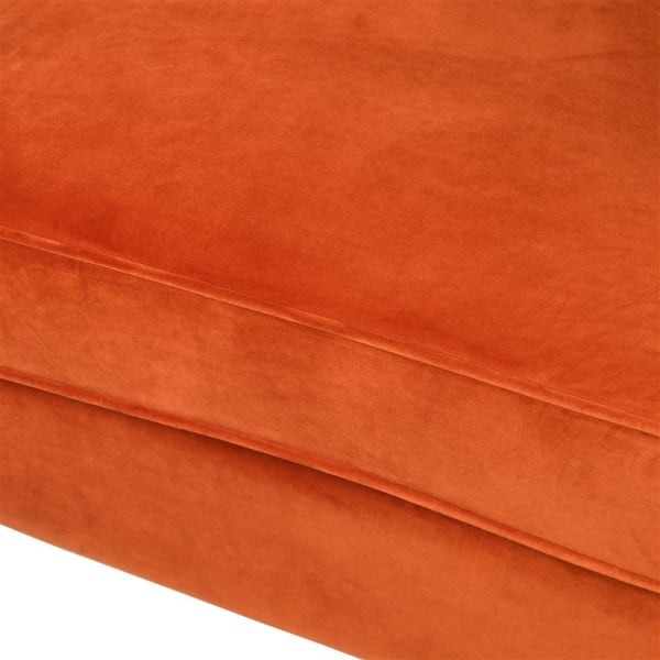 Orange upholstered chair with a curved wraparound back